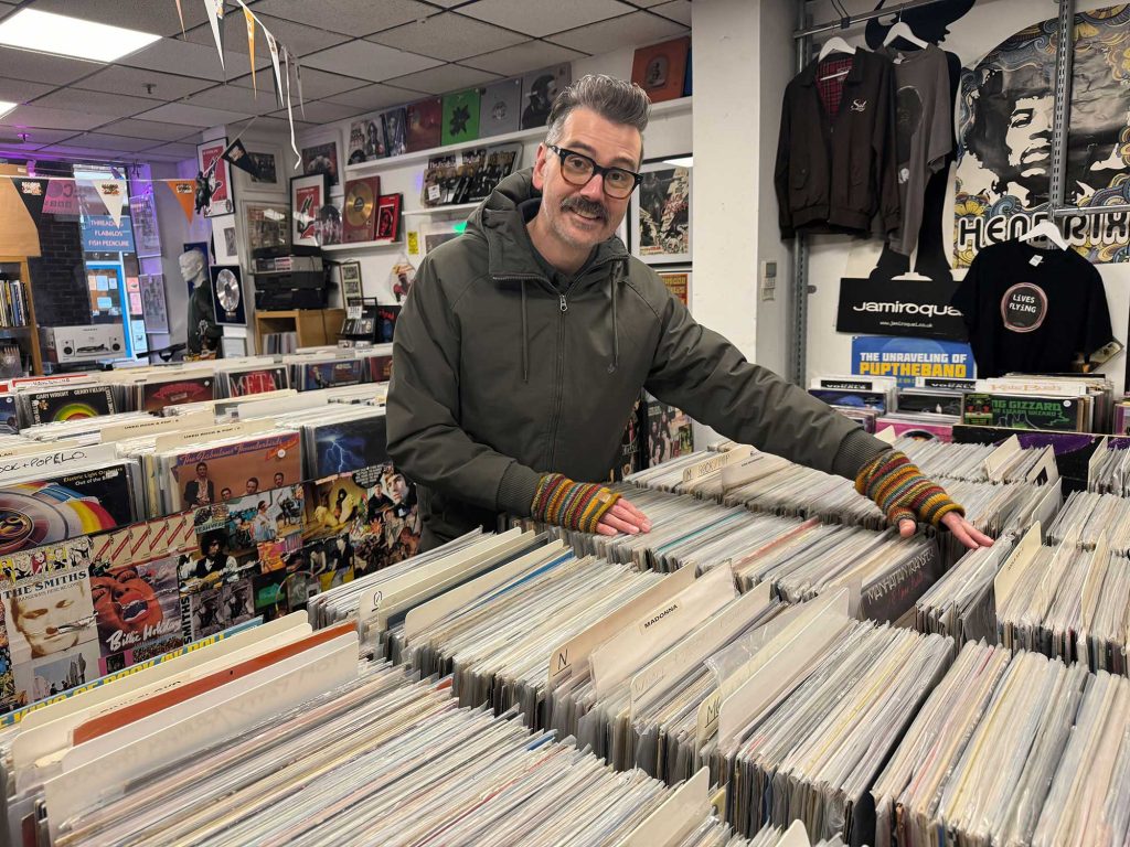 Mark flicking through vinyl in a record store